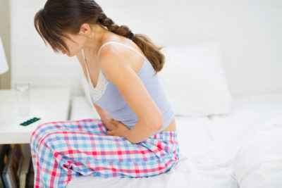 Reizmagen - Frau mit Bauchschmerzen auf der Bettkante (c) Depositphotos @CITAlliance